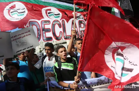 Palestinians hold banners during a demonstration in Gaza City to mark the anniversary of the Balfour Declaration on October 29, 2016. The 1917 Balfour Declaration is a formal statement of policy by the British government...