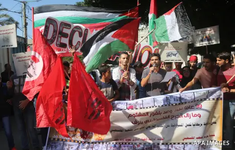 Palestinians hold banners during a demonstration in Gaza City to mark the anniversary of the Balfour Declaration on October 29, 2016. The 1917 Balfour Declaration is a formal statement of policy by the British government...