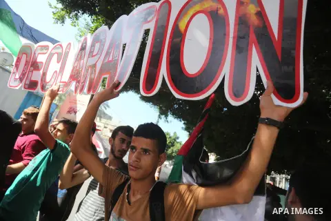 Palestinians hold banners during a demonstration in Gaza City to mark the anniversary of the Balfour Declaration on October 29, 2016. The 1917 Balfour Declaration is a formal statement of policy by the British government...