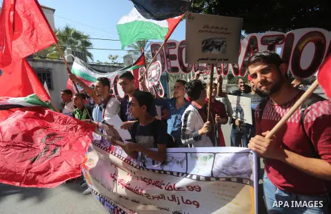 Palestinians hold banners during a demonstration in Gaza City to mark the anniversary of the Balfour Declaration on October 29, 2016. The 1917 Balfour Declaration is a formal statement of policy by the British government...