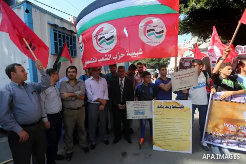Palestinians hold banners during a demonstration in Gaza City to mark the anniversary of the Balfour Declaration on October 29, 2016. The 1917 Balfour Declaration is a formal statement of policy by the British government...