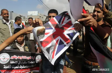 Palestinians burn Israeli and British flags during a demonstration to mark the anniversary of the Balfour Declaration, in Rafah in the southern Gaza strip, on November 1, 2016. The 1917 Balfour Declaration is a formal st...