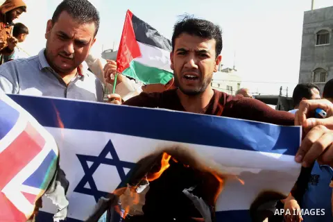 Palestinians burn Israeli and British flags during a demonstration to mark the anniversary of the Balfour Declaration, in Rafah in the southern Gaza strip, on November 1, 2016. The 1917 Balfour Declaration is a formal st...