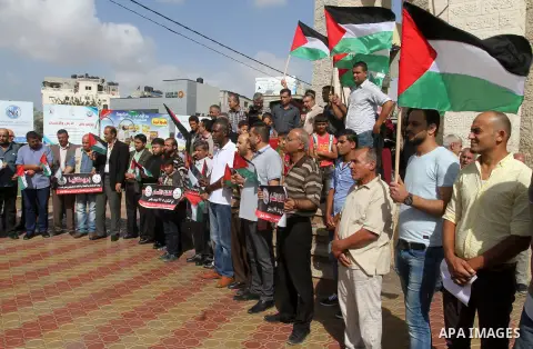 Palestinians hold banners during a demonstration to mark the anniversary of the Balfour Declaration, in Rafah in the southern Gaza strip, on November 1, 2016. The 1917 Balfour Declaration is a formal statement of policy...