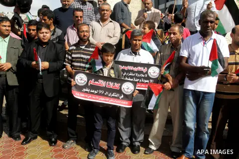 Palestinians hold banners during a demonstration to mark the anniversary of the Balfour Declaration, in Rafah in the southern Gaza strip, on November 1, 2016. The 1917 Balfour Declaration is a formal statement of policy...