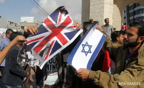 Palestinians burn Israeli and British flags during a demonstration to mark the anniversary of the Balfour Declaration, in Rafah in the southern Gaza strip, on November 1, 2016. The 1917 Balfour Declaration is a formal st...