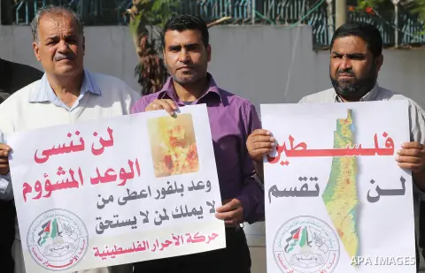 Palestinians hold banners during a demonstration to mark the anniversary of the Balfour Declaration, outside the UNESCO headquarters in Gaza city, on November 2, 2016. The 1917 Balfour Declaration is a formal statement o...
