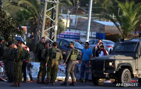 Members of Israeli security forces gather at the site where Israeli troops shot dead a Palestinian who attempted to stab a soldier near the West Bank settlement of Ofra on November 3, 2016. Photo by Shadi Hatem