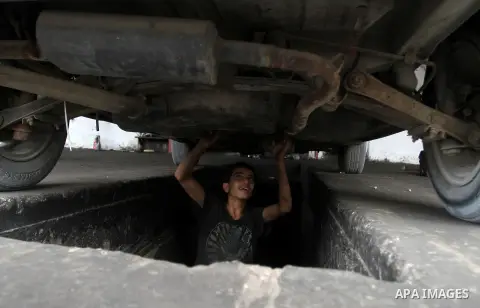 A Palestinian boy works at a mechanic shop in Rafah in the southern Gaza strip, on November 7, 2016. Photo by Abed Rahim Khatib