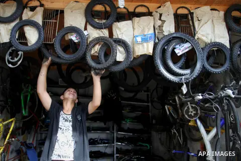 A Palestinian boy works at a mechanic shop in Rafah in the southern Gaza strip, on November 7, 2016. Photo by Abed Rahim Khatib