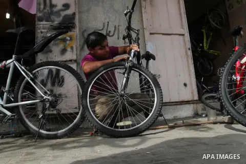 A Palestinian boy works at a mechanic shop in Rafah in the southern Gaza strip, on November 7, 2016. Photo by Abed Rahim Khatib