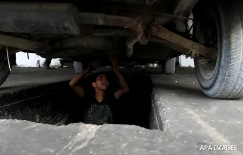 A Palestinian boy works at a mechanic shop in Rafah in the southern Gaza strip, on November 7, 2016. Photo by Abed Rahim Khatib