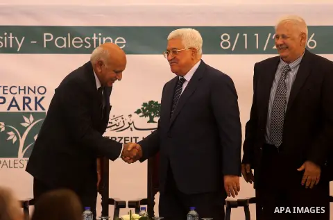 Palestinian President Mahmoud Abbas shakes hands with Mobashar Jawad Akbar, India's Minister of State for External Affairs, during a ceremony of laying the foundation stone of Palestine-India Techno Park, near the West B...