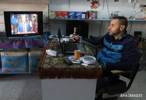 A Palestinian man watches Donald Trump's victory speech on TV in Rahaf in the southern Gaza strip, on November 9, 2016. U.S. Republican Donald Trump has been elected the 45th president of the United States after defeated...