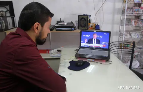 A Palestinian man watches Donald Trump's victory speech on TV in Rahaf in the southern Gaza strip, on November 9, 2016. U.S. Republican Donald Trump has been elected the 45th president of the United States after defeated...