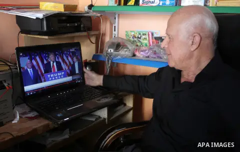 A Palestinian man watches Donald Trump's victory speech on TV in Rahaf in the southern Gaza strip, on November 9, 2016. U.S. Republican Donald Trump has been elected the 45th president of the United States after defeated...