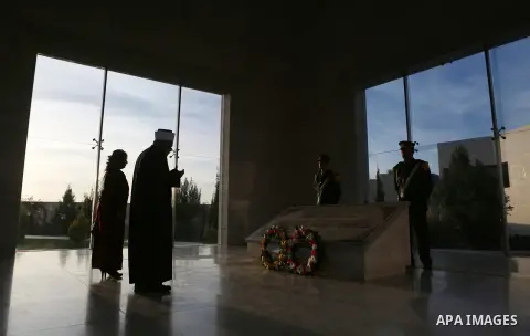 A Palestinian man prays in front of the tomb of the late Palestinian leader Yasser Arafat during the inauguration ceremony of late Palestinian leader Yasser Arafat's Museum in the West Bank city of Ramallah on November 9...