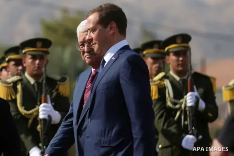 Palestinian President Mahmud Abbas and Russian Prime Minister Dmitry Medvedev review the honour guard ahead of a meeting in the West Bank city of Jericho, on November 11, 2016. Photo by Shadi Hatem