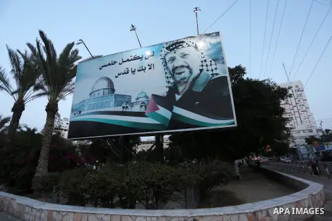 A Picture taken on November 11, 2016 shows a poster of the late Palestinian leader Yasser Arafat, on the 12 anniversary of his death in Gaza city. Photo by Mohammed Asad