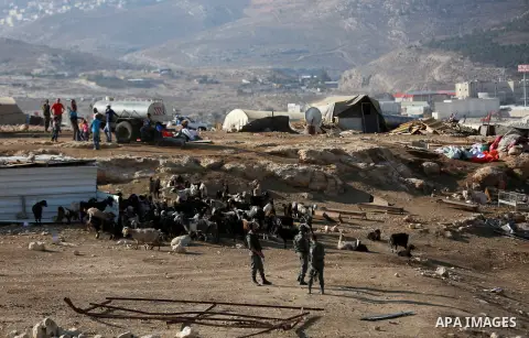 Israeli security forces confiscate barracks in the Palestinian Bedouin residential area after Israeli authorities said it was built without a permit in the West Bank village of Jab'a, north east of Jerusalem on Nov. 15,...