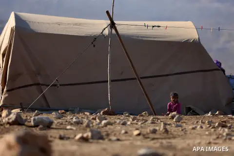 A Palestinian Bedouin girl plays outside her family tent as Israeli security forces confiscate barracks in the Bedouin residential area after Israeli authorities said it was built without a permit in the West Bank villag...