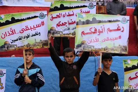 Palestinian Hamas supporters take part during a protest against a controversial Israeli bill to limit the volume of calls to prayer at mosques in the occupied Jerusalem, in Jabalia in the northern Gaza Strip, on Nov. 18,...