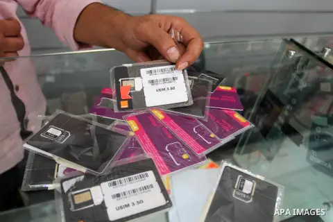 A Palestinian man displays SIM cards of Cellcom and Partner from Israeli cellular providers, in a mobile phone shop in Rafah in the southern Gaza strip, on November 20, 2016. Interior Ministry in Gaza are trying to stop...