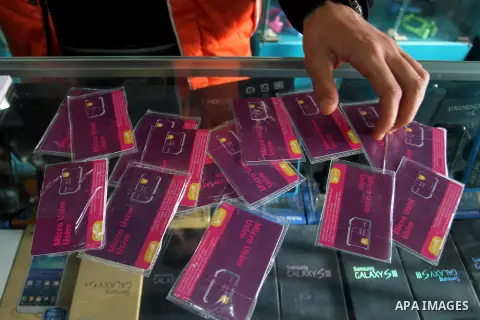 A Palestinian man displays SIM cards of Cellcom and Partner from Israeli cellular providers, in a mobile phone shop in Rafah in the southern Gaza strip, on November 20, 2016. Interior Ministry in Gaza are trying to stop...