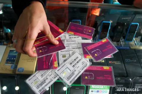 A Palestinian man displays SIM cards of Cellcom and Partner from Israeli cellular providers, in a mobile phone shop in Rafah in the southern Gaza strip, on November 20, 2016. Interior Ministry in Gaza are trying to stop...