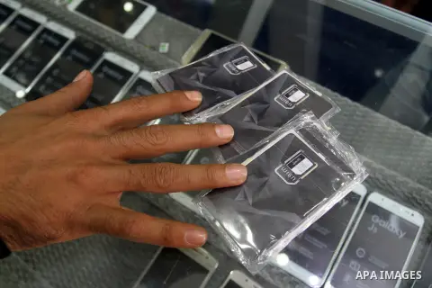 A Palestinian man displays SIM cards of Cellcom and Partner from Israeli cellular providers, in a mobile phone shop in Rafah in the southern Gaza strip, on November 20, 2016. Interior Ministry in Gaza are trying to stop...