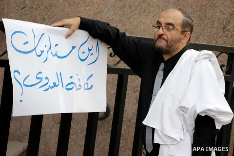 Egyptian doctors hold banners during a protest against shortage of medical supplies, outside the State Council's building, Egypt's highest administrative court, in Cairo on Nov. 20, 2016. Doctors are being told to reuse...