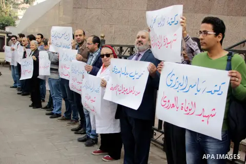 Egyptian doctors hold banners during a protest against shortage of medical supplies, outside the State Council's building, Egypt's highest administrative court, in Cairo on Nov. 20, 2016. Doctors are being told to reuse...