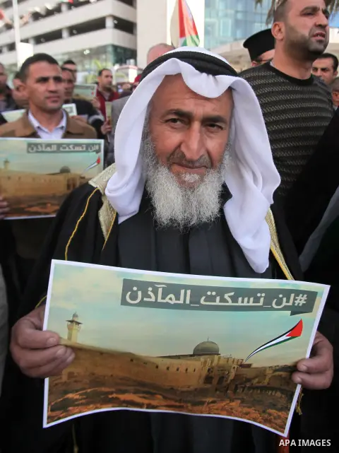 Palestinians hold banners during a protest against a controversial Israeli bill to limit the volume of calls to prayer at mosques in the occupied Jerusalem, in the West Bank city of Nablus on Nov. 20, 2016. Israeli Prime...