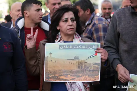Palestinians hold banners during a protest against a controversial Israeli bill to limit the volume of calls to prayer at mosques in the occupied Jerusalem, in the West Bank city of Nablus on Nov. 20, 2016. Israeli Prime...