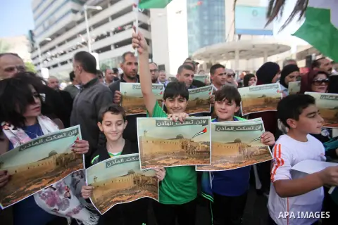 Palestinians hold banners during a protest against a controversial Israeli bill to limit the volume of calls to prayer at mosques in the occupied Jerusalem, in the West Bank city of Nablus on Nov. 20, 2016. Israeli Prime...