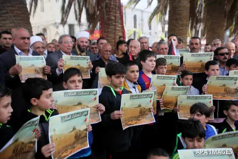 Palestinians hold banners during a protest against a controversial Israeli bill to limit the volume of calls to prayer at mosques in the occupied Jerusalem, in the West Bank city of Nablus on Nov. 20, 2016. Israeli Prime...