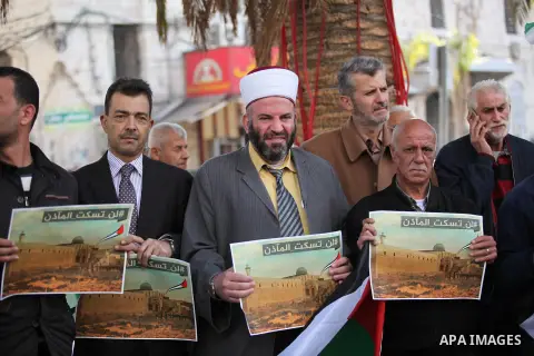 Palestinians hold banners during a protest against a controversial Israeli bill to limit the volume of calls to prayer at mosques in the occupied Jerusalem, in the West Bank city of Nablus on Nov. 20, 2016. Israeli Prime...