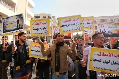Palestinians hold banners during a protest to show solidarity with Palestinian prisoners on hunger strike in Israeli Jails, in front of the high commissioner for human rights headquarters in Gaza City, on November 22, 20...