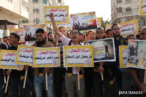 Palestinians hold banners during a protest to show solidarity with Palestinian prisoners on hunger strike in Israeli Jails, in front of the high commissioner for human rights headquarters in Gaza City, on November 22, 20...