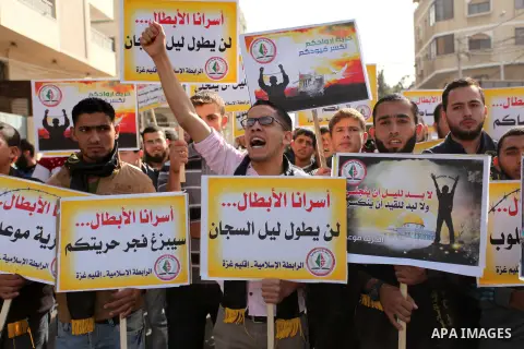 Palestinians hold banners during a protest to show solidarity with Palestinian prisoners on hunger strike in Israeli Jails, in front of the high commissioner for human rights headquarters in Gaza City, on November 22, 20...