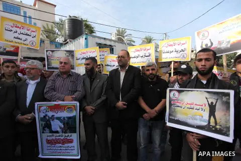 Palestinians hold banners during a protest to show solidarity with Palestinian prisoners on hunger strike in Israeli Jails, in front of the high commissioner for human rights headquarters in Gaza City, on November 22, 20...