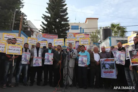 Palestinians hold banners during a protest to show solidarity with Palestinian prisoners on hunger strike in Israeli Jails, in front of the high commissioner for human rights headquarters in Gaza City, on November 22, 20...