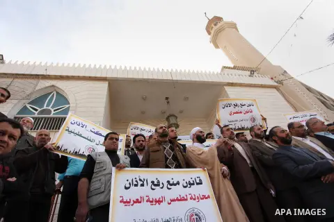 Palestinians hold banners during a protest against a controversial Israeli bill to limit the volume of calls to prayer at mosques in the occupied Jerusalem, in Gaza city on November 23, 2016. Israeli Prime Minister Benja...