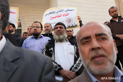 Palestinians hold banners during a protest against a controversial Israeli bill to limit the volume of calls to prayer at mosques in the occupied Jerusalem, in Gaza city on November 23, 2016. Israeli Prime Minister Benja...