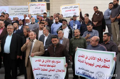 Palestinians hold banners during a protest against a controversial Israeli bill to limit the volume of calls to prayer at mosques in the occupied Jerusalem, in Gaza city on November 23, 2016. Israeli Prime Minister Benja...