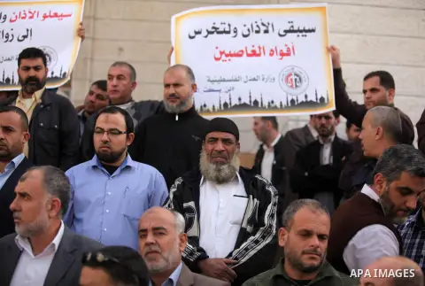 Palestinians hold banners during a protest against a controversial Israeli bill to limit the volume of calls to prayer at mosques in the occupied Jerusalem, in Gaza city on November 23, 2016. Israeli Prime Minister Benja...