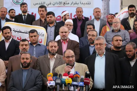 Palestinians hold banners during a protest against a controversial Israeli bill to limit the volume of calls to prayer at mosques in the occupied Jerusalem, in Gaza city on November 23, 2016. Israeli Prime Minister Benja...