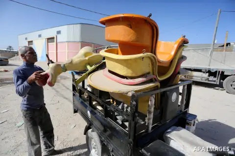 Palestinian men work on the manufacture and maintenance of the swings "amusement games" at al-salam factory in the Zeitoun neighborhood, in Gaza city, on November 26, 2016. Israeli occupation prevented of the introductio...