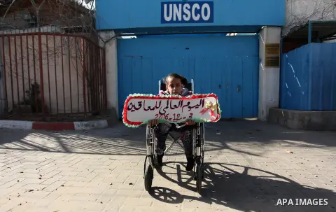 Palestinians and physically challenged people take part in a rally marking the International Day of Persons with Disabilities, outside the UNESCO headquarters in Gaza city, on December 1, 2016. Photo by Ashraf Amra
