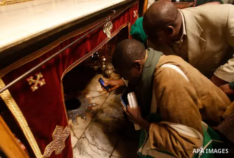 Visitors visit the holy star where Jesus Christ is believed to have been born inside the holy cave in the Church of Nativity during a Christmas tree lighting ceremony in the West Bank town of Bethlehem December 3, 2016....